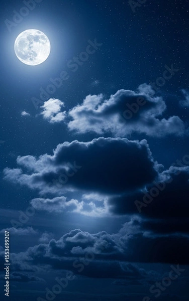 Fototapeta A beautiful full moon lights up the night sky with glowing clouds drifting peacefully across the dark blue atmosphere. 