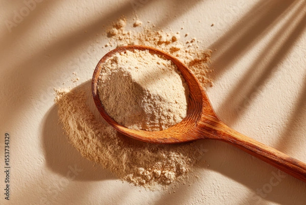 Obraz Ayurvedic powder in wooden spoon with shadow on background