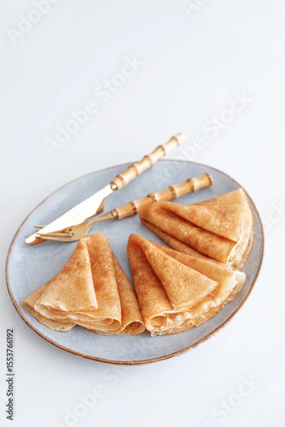 Obraz Golden crepes on white wooden table. Pancake day, Maslenitsa. Top view