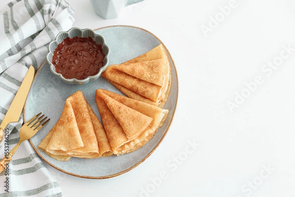 Obraz Crepes with chocolate cream and coffee on white wooden table. Pancake day, Maslenitsa. Top view