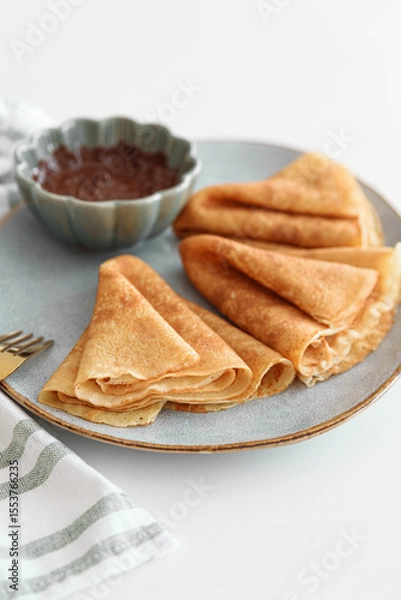 Obraz Crepes with chocolate cream and coffee on white wooden table. Pancake day, Maslenitsa