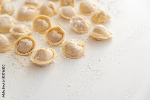Obraz Raw homemade dumplings dusted with flour.