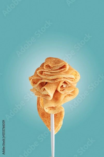 Obraz Golden pancakes on a fork against a vibrant blue background.