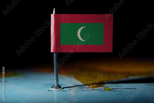 Fototapeta Small Maldives flag pinned on map, highlighting the island nation location in the Indian Ocean