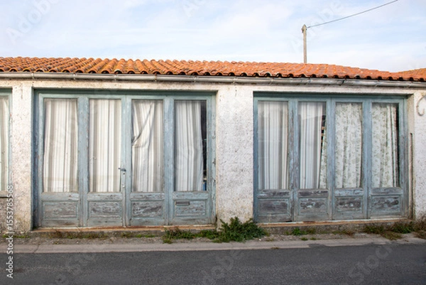Fototapeta two door entrance facade of an old store converted into a dwelling ancient dilapidated apartment