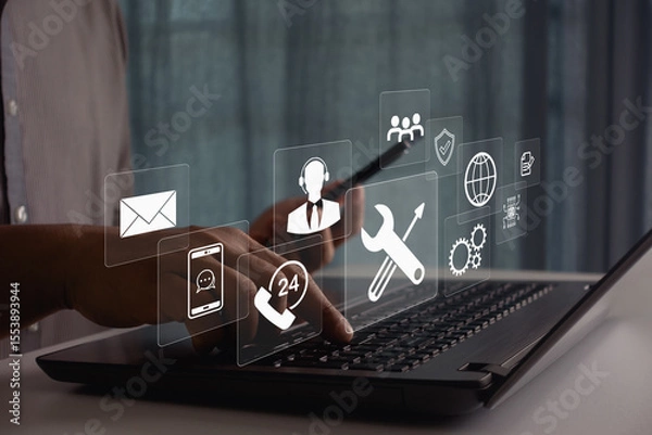 Fototapeta Businessman using laptop and smartphone for 24/7 customer support, technical assistance, and online service with digital communication icons, global technology. Concept for consulting and remote help.