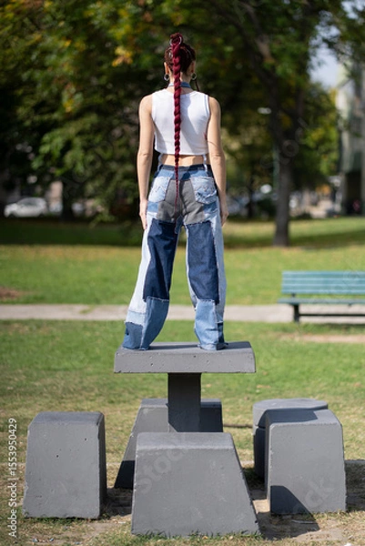 Fototapeta Rear view of woman with red braids and innovative patchwork style