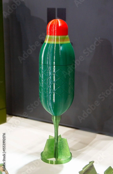 Fototapeta Bomb. Bomb model for drone. Model of bomb printed on 3D printer from melted plastic. Body of bomb with tail created on 3D printer. Prototype of ammunition printed on 3D printer. Innovation 3d printing