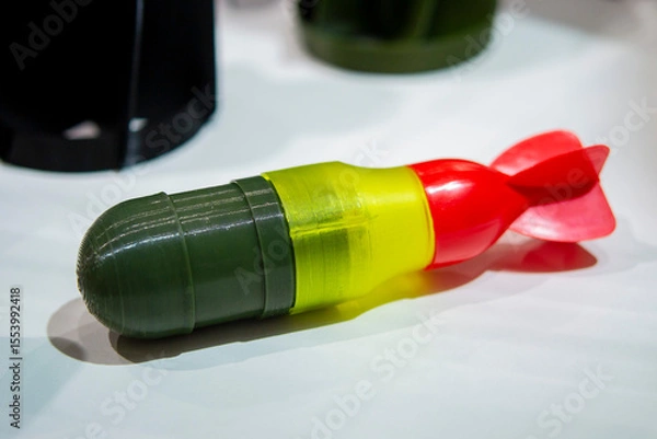 Fototapeta Bomb. Bomb model for drone. Model of bomb printed on 3D printer from melted plastic. Body of bomb with tail created on 3D printer. Prototype of ammunition printed on 3D printer. Innovation 3d printing