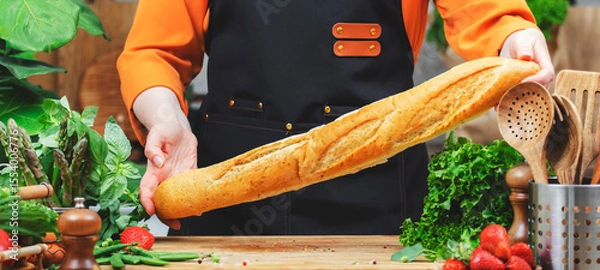Fototapeta skilled chef focuses on healthy cooking using fresh baguette bread, vegetables and healthy ingredients, showcasing passion for vegan lifestyle in kitchen.