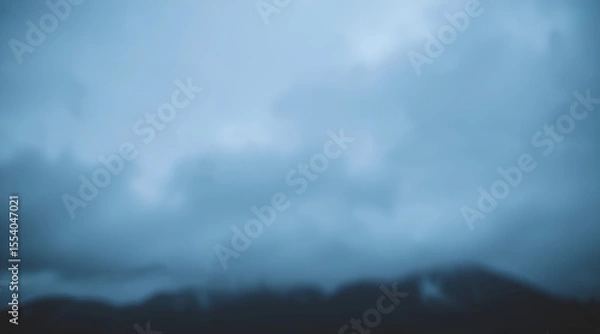 Fototapeta Blurred clouds over dark mountains. Dramatic gloomy sky. AI generation.