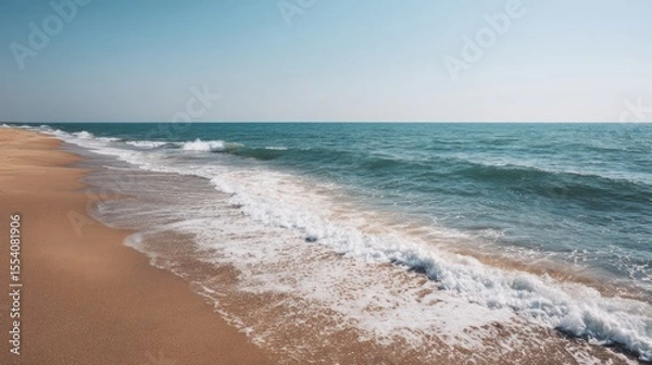 Fototapeta Calm seascape view with beach and foamy waves rolling on the shore