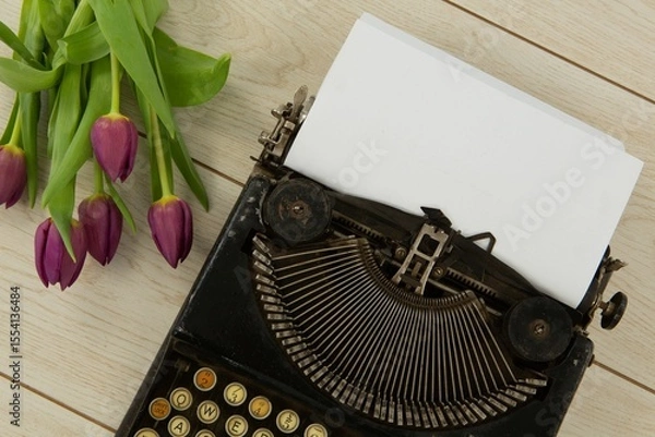 Fototapeta Typewriter and flowers on table