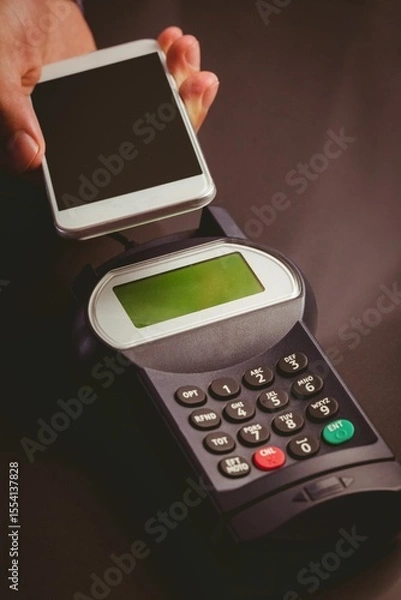 Obraz Man using smartphone to express pay