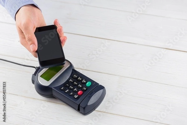 Fototapeta Flat design retail transaction showing tapping smartphone on white counter POS terminal, copy space