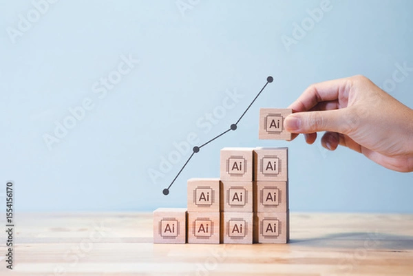 Fototapeta A hand stacking wooden blocks labeled with "AI" icons, forming a staircase graph that symbolizes the rising development and impact of artificial intelligence.