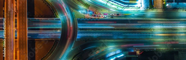 Obraz Expressway top view, Road traffic an important infrastructure, car traffic transportation above intersection road in city night, aerial view cityscape of advanced innovation, financial technology