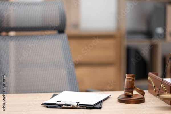 Fototapeta Judge's gavel, clipboards and scales on wooden table in office