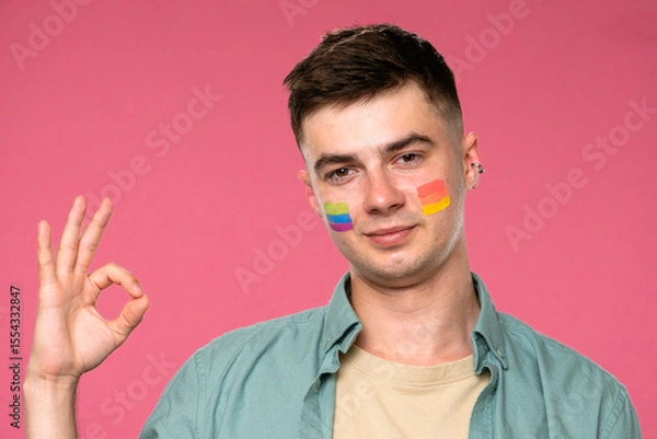 Fototapeta Expressive Portrait of Young Person with Rainbow Colors on Cheeks