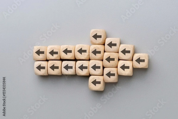 Obraz A large arrow formed by multiple wooden blocks with black arrows pointing in the opposite direction. Resistance to change, conflicting directions, stubbornness concept.