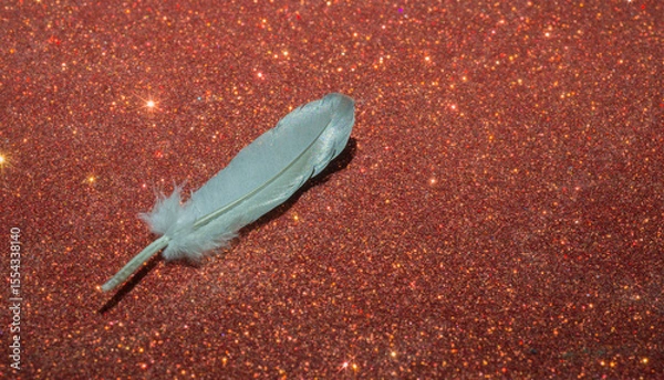 Fototapeta feather of a bird on a red background. close-up