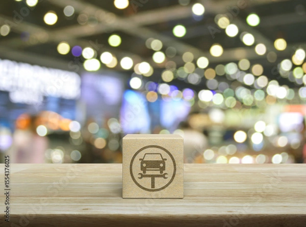 Fototapeta Service fix car with wrench tool flat icon on wood block cube on wooden table over blur light and shadow of shopping mall, Business repair car service concept
