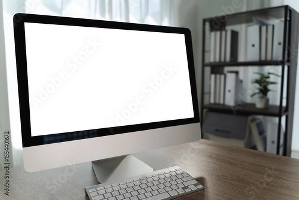 Obraz Computer with blank screen on table modern desktop computer with large screen and keyboard wooden desk bright office space. background features