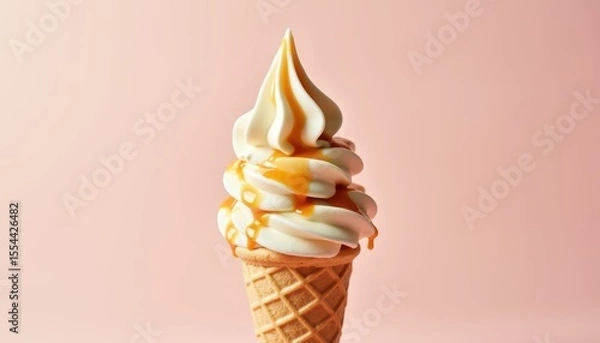 Fototapeta Delicious Soft Serve Ice Cream Cone with Caramel Drizzle on Light Pink Background