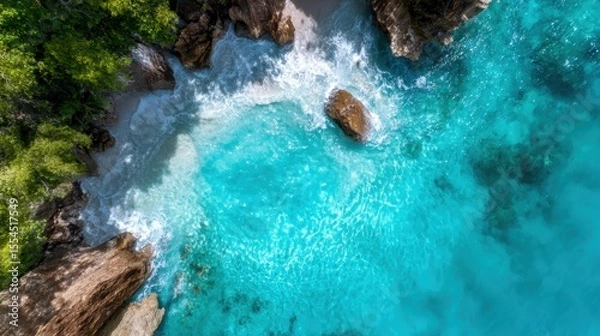 Obraz Breathtaking aerial view of turquoise waters crashing against a rocky shoreline reveals nature's dynamic beauty and the enchanting contrast between land and sea.