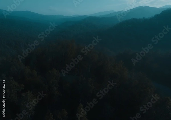 Fototapeta Ethereal mountains shrouded in calming mist