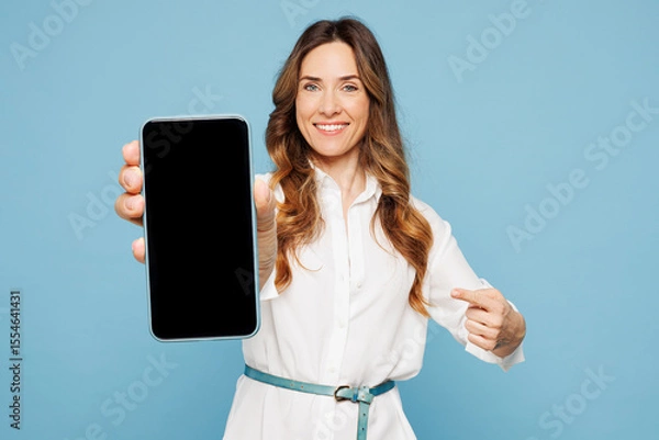 Fototapeta Young employee business woman corporate lawyer in shirt classic formal clothes work in office hold use point on blank screen area mobile cell phone isolated on pastel blue background studio portrait