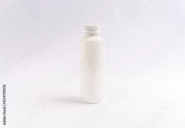 Fototapeta white plastic bottle with a twist cap on a white background