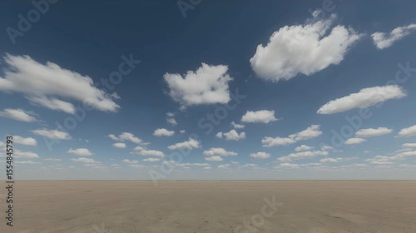 Fototapeta Wide open expanse of light beige desert under a partly cloudy, vibrant blue sky