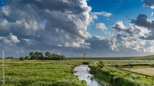 Obraz Gewitterwolken über dem Pilsumer Leuchtturm in Ostfriesland, Deutschland