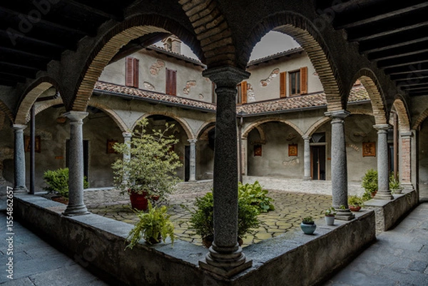 Fototapeta Historic Stone Monastery With Inner Courtyard And Arched Walkways: Peaceful Cloister Architecture In Northern Italy