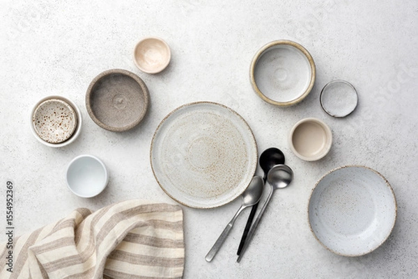 Fototapeta Collection of different ceramic plates and bowls for food photography and cooking, top view