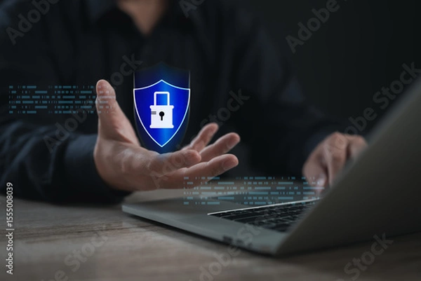 Fototapeta Businessman presenting a digital shield with padlock icon, representing data protection, cyber security, privacy defense, and secure online systems in modern technology environments.