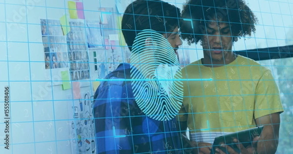 Fototapeta Two colleagues in blue and yellow shirts examining tablet with fingerprint grid overlay in office