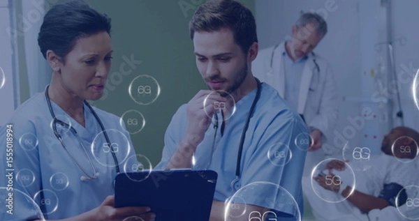 Obraz Medical professionals discussing patient data with 6G technology image overlay