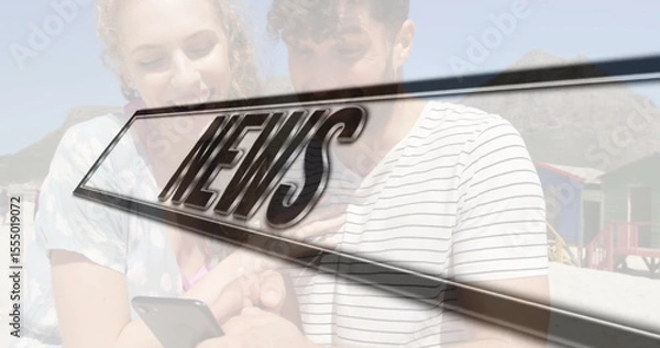 Obraz Smiling couple sharing smartphone on sand, with colorful wooden beach huts and NEWS graphic overlay
