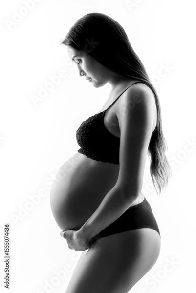 Fototapeta Expecting pregnant woman in a high contrast black and white portrait.
Great shades of grey to convey the values around maternity, parenting, prepare and expect for baby.