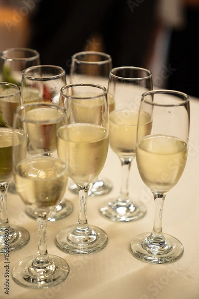 Obraz Close-up of Champagne Flutes Filled with Sparkling Wine at a Celebration Event