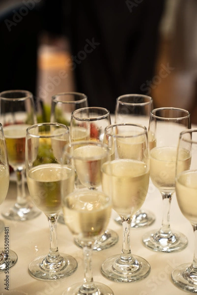 Obraz Champagne Glasses on Table at Celebration Event with Bokeh Background
