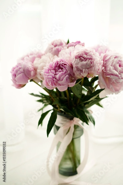 Obraz Fresh bouquet of pink peonies in a glass vase with ribbon