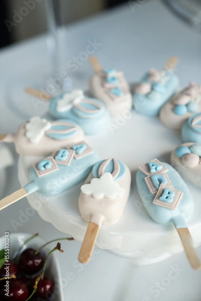 Obraz Colorful decorated ice cream pops on a white plate with cherries and elegant table setting