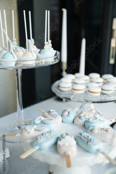 Obraz Elegant Blue and White Dessert Table with Cake Pops, Macarons, and Candied Treats for a Special Event
