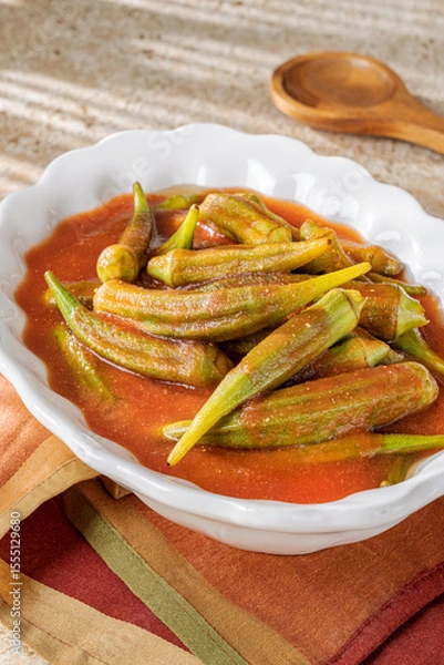 Fototapeta Okra plate with tomato sauce.
Delicious stew made with Bamya vegetables found all over the east Mediterranean cultures.