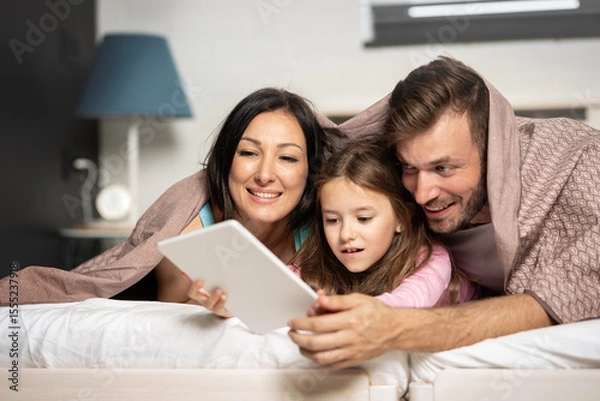 Obraz Happy family using tablet together bed images