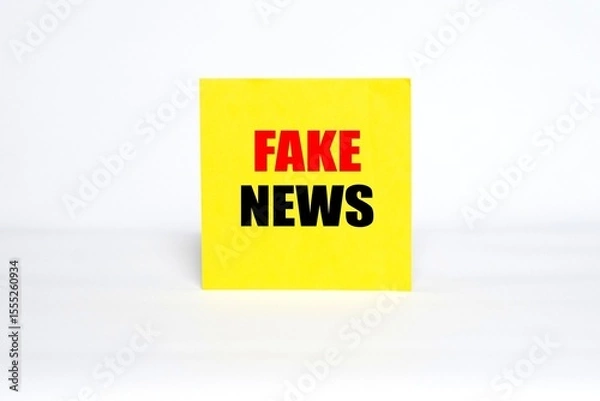 Fototapeta "FAKE NEWS" writing concept on sticky notes isolated on white background.