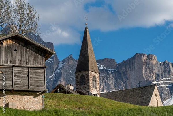 Fototapeta Close-up view of Santa Maddalena Church in the green valley of South Tyrol with forested hills in the background.